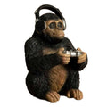 Statue of a monkey wearing headphones and holding a music player on a white background-Mystic-Cave
