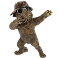 Bronze statue of a dog wearing sunglasses, hat, and chain with pendant on a white background-Mystic-Cave