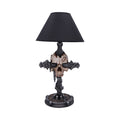 Decorative table lamp with skull and cross design on a white background