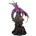 Dragon sculpture with purple and silver wings on top of a thatched-roof structure.mystic-cave