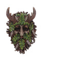 Decorative mask with green leaves, brown antlers, and pinecones on a white background mystic-cave.co.uk