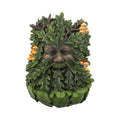 Green leafy creature figurine with a face made of leaves on a white background