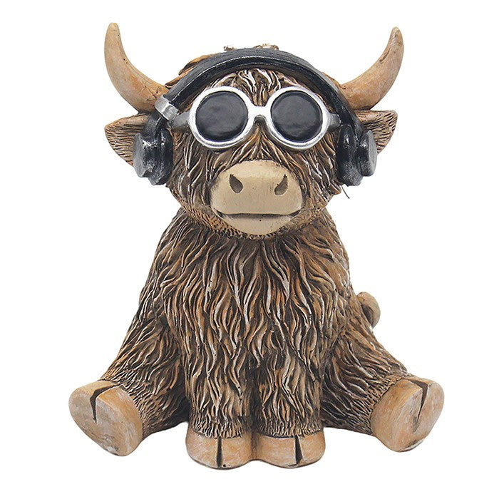 A decorative Highland cow figurine with textured brown fur, light tan horns and feet, wearing black headphones and round black-and-silver sunglasses, shown on a plain white background.