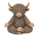 A decorative figurine of a seated Highland cow with long shaggy brown fur, cream-colored horns and muzzle, and tan hooves, shown on a plain white background.