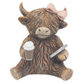 Statue of a highland cow with a bow, holding a coffee cup and phone on a white background