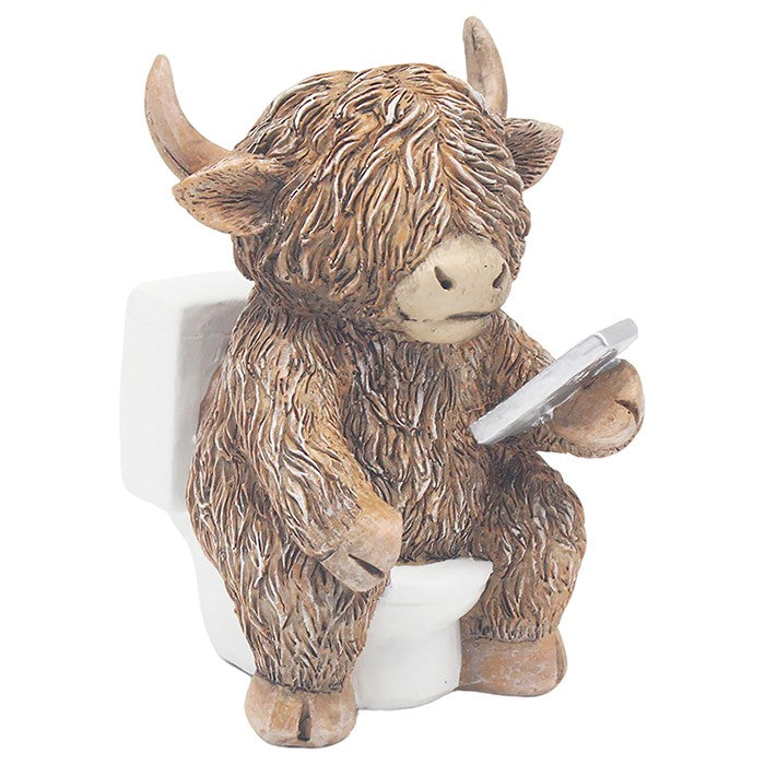 Statue of a Highland cow holding a silver disc on a white background