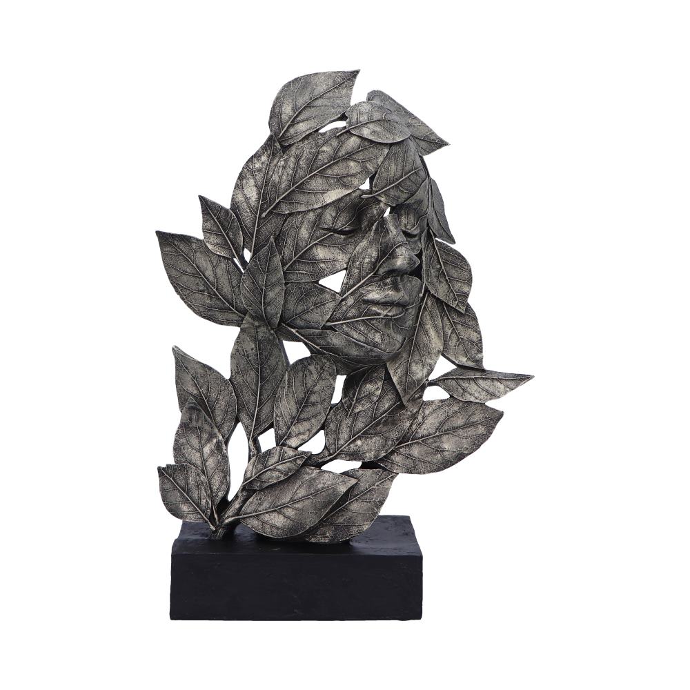 Decorative metal leaf sculpture on a black base against a white background