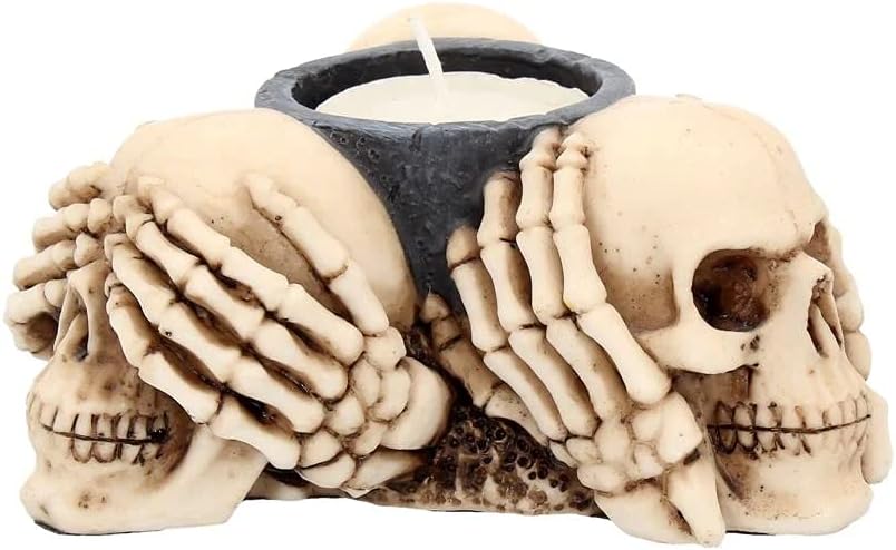Skull-shaped candle holder with a candle inside on a white background