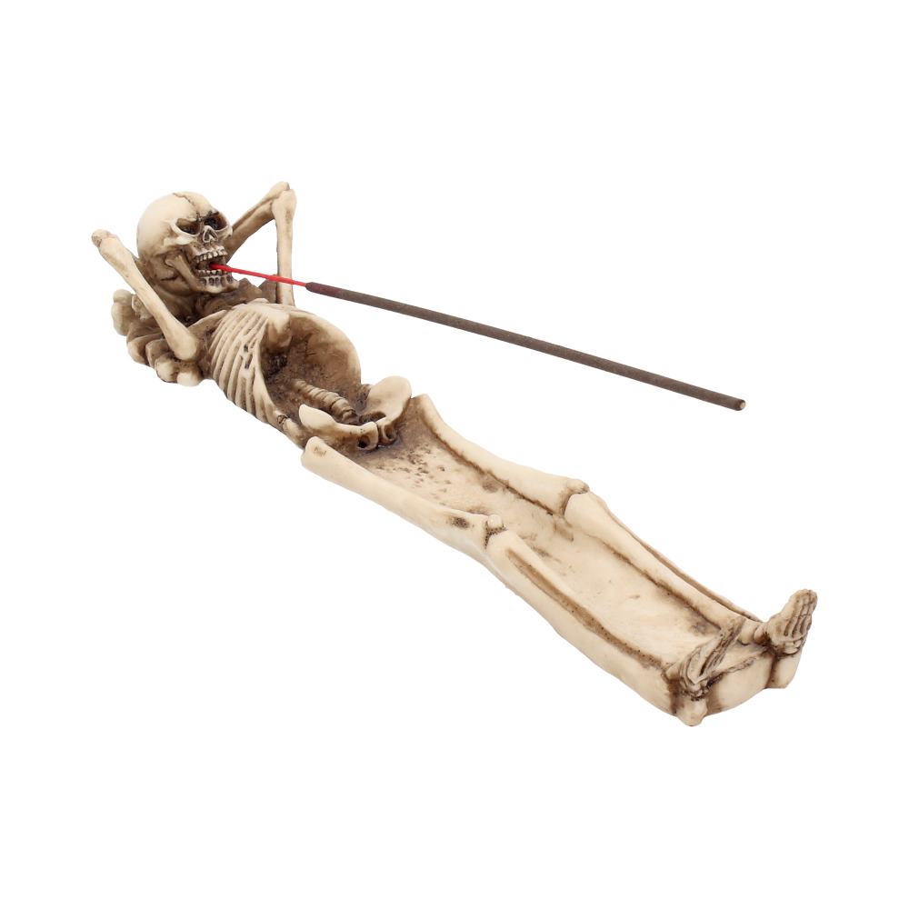 Skeletal figure holding incense sticks on a white background mystic cave